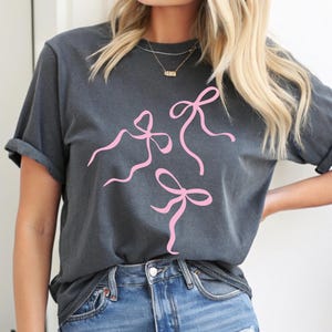 Coquette Bow Graphic Tee, Pink Bow Shirt, Cute Ribbon, Women Casual Top, Bow Design, Simple Pink Bow Top, Gift for Her, Gen Z, Trendy 2025