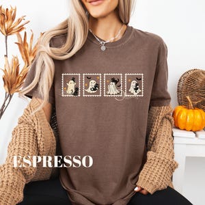 May include: Espresso-colored t-shirt featuring a Halloween-themed design. The design includes four postage stamp-style images with cartoon ghosts and black cats. The word "ESPRESSO" is printed in large white letters at the bottom of the shirt.