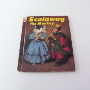 May include: Vintage children's book titled "Scalawag the Monkey." The cover features illustrations of a cat and a monkey dressed in clothing. The book has a brown cover with yellow text. The book is a Rand McNally Elf Book.