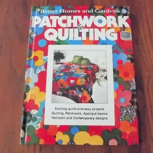 May include: A book titled "Better Homes and Gardens Patchwork & Quilting" with a colorful floral design. The cover features a photo of a quilt with a floral pattern. Text on the cover includes "Exciting quick-and-easy projects" and "Heirloom and Contemporary designs."
