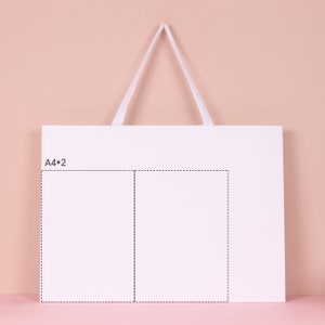 May include: A white rectangular shopping bag with a white handle against a pink background. The bag has a smaller rectangular area outlined with a dotted line, with the text "A4*2" in the upper left corner.