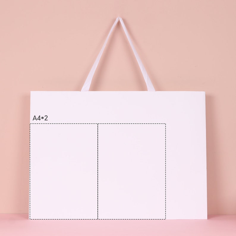 May include: A white rectangular shopping bag with a white handle against a pink background. The bag has a smaller rectangular area outlined with a dotted line, with the text "A4*2" in the upper left corner.