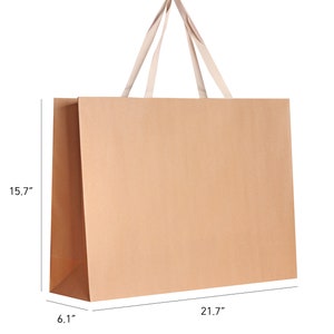 May include: A large, rectangular brown paper shopping bag with cream-colored handles. The bag measures 21.7 inches long, 15.7 inches high, and 6.1 inches wide. The handles are made of a soft, woven material.
