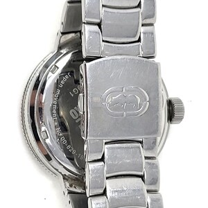 May include: Close-up of a silver-toned wristwatch with a metal band. The watch face is visible, with the words "Japan movement" and "G1" printed on it. The clasp features a logo.