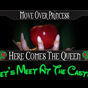 May include: Black license plate frame with the text "MOVE OVER PRINCESS" and "HERE COMES THE QUEEN". The frame features a red apple held by a hand with long nails, and the text "Let's Meet At The Castle".