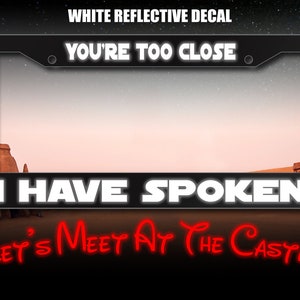 May include: White reflective decal with the text "You're Too Close. I Have Spoken. Let's Meet At The Castle" in a black frame. The decal is set against a desert landscape.