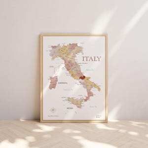 Könnte beinhalten: Eine gerahmte Karte von Italien, mit Regionen in Erdtönen. Das Wort "ITALY" steht oben, mit Namen von Meeren und Inseln. Die Karte befindet sich in einem hellen Holzrahmen. Maße sind nicht zutreffend.