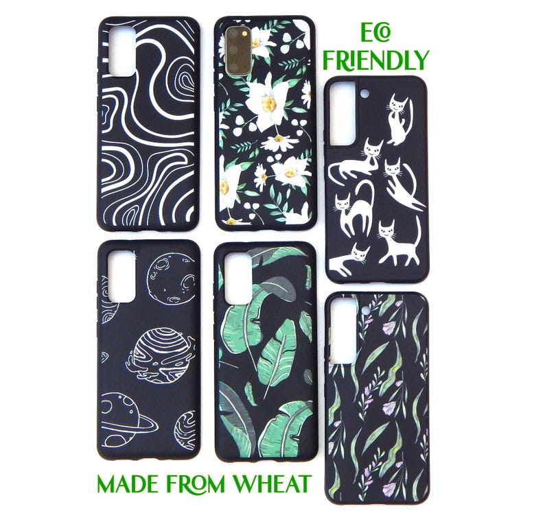 May include: Six black phone cases with various designs. Patterns include white swirls, white flowers, white cat silhouettes, planets, green leaves, and a floral design. The text "E@ FRIENDLY" and "MADE FROM WHEAT" are also visible.