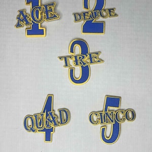 May include: Five embroidered patches in blue and gold. Each patch features a number from one to five, with the corresponding word in a stylized font. The words are Ace, Deuce, Tre, Quad, and Cinco.