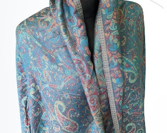 May include: A blue, green, and pink paisley patterned shawl with fringed edges.