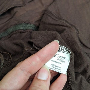 May include: A white tag with black text that reads "FLOWER GARDEN" and "COMPOSITION: 90% Dacron 10% spandex MADE IN TURKEY".