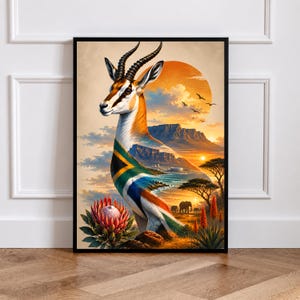 May include: A framed wall art print featuring a springbok with a double exposure effect. The animal's body incorporates the South African flag, Table Mountain, and a sunset landscape with elephants and protea flowers in warm orange and gold tones.