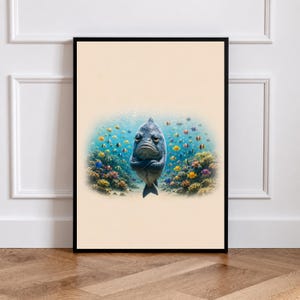 May include: A framed wall art print featuring a central, grumpy-looking grey fish with crossed fins, positioned in front of a vibrant coral reef scene filled with numerous small, colorful tropical fish against a light beige background.