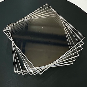 May include: A stack of clear acrylic sheets, likely for crafting or DIY projects.