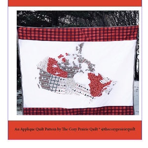 May include: A white quilt with a red and black plaid border. The quilt features an applique design of Canada with red and white accents. The quilt is titled "O Canada Quilt!" and is an applique quilt pattern by The Cozy Prairie Quilt.