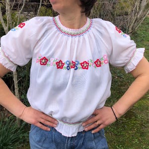 Vintage 70s does 40s Hungarian traditional blouse. White blouse with bright floral hand embroidery. S/M size.