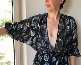 Vintage 80s transparent black wrap blouse with rainbow lurex floral pattern. Sheer batwing sleeve party blouse.