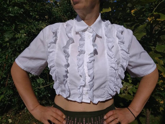 White cotton crop top decorated with eyelet lace.