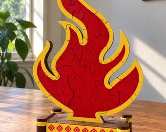 May include: A wooden flame-shaped jigsaw puzzle featuring a vibrant red center with a yellow border. The puzzle stands upright on a rectangular wooden platform base decorated with a repeating red diamond pattern and four dark brown corner posts.