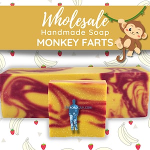 May include: Three bars of handmade soap with a yellow and red swirl pattern. The soap is labeled "MONKEY FARTS" and is on a white background with a pattern of bananas and strawberries.
