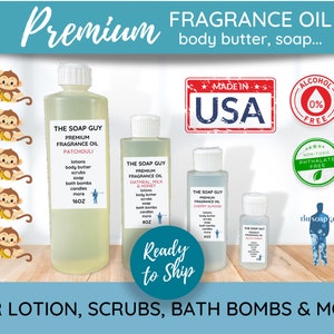 May include: Four bottles of fragrance oil labeled "The Soap Guy Premium Fragrance Oil" in the scents Patchouli, Oatmeal, Milk & Honey, Cherry Almond, and Black Honey. The bottles are on a wooden surface with a "Ready to Ship" label. The image also includes a "Made in USA" label, a "0% Alcohol Free" label, and a "Non-Toxic Phthalate Free" label.