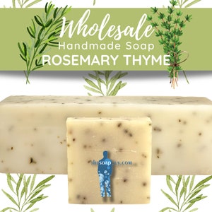 May include: Two bars of handmade soap, one large and one small, with a white base and flecks of green herbs. The soap is labeled "Wholesale Handmade Soap Rosemary Thyme".