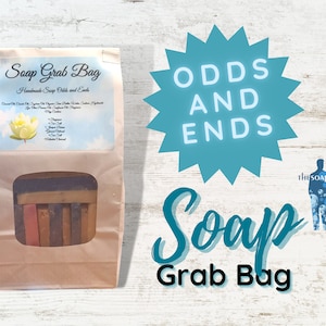 May include: A brown paper bag with a window showing a variety of handmade soap bars. The bag is labeled "Soap Grab Bag" and "Handmade Soap Odds and Ends". The text "ODDS AND ENDS Soap Grab Bag" is written in blue on a teal starburst.