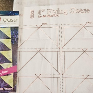 May include: A sewing pattern and a booklet for making 4-inch Flying Geese quilt blocks. The pattern is printed on white fabric with brown lines. The booklet has a colorful design with the text "smart-ease" and "4" Flying Geese".