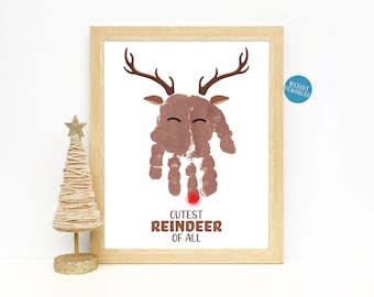 May include: A printable handprint art project for kids featuring a brown reindeer with a red nose and the text "Cutest Reindeer of All".