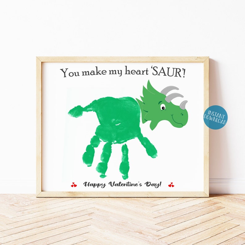 May include: A printable Valentine's Day card featuring a green dinosaur made from a handprint. The card says "You make my heart 'SAUR!'".  Happy Valentine's Day! is written below the dinosaur.