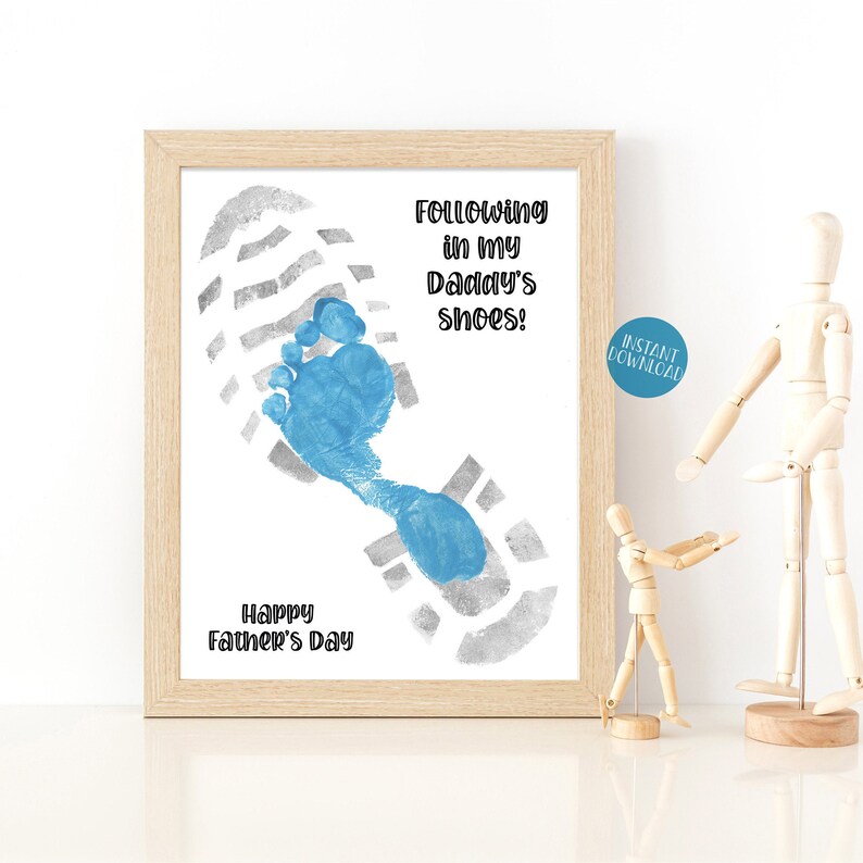 May include: A printable Father's Day card with a blue footprint inside a gray footprint. The text reads "Following in my Daddy's shoes!" and "Happy Father's Day".