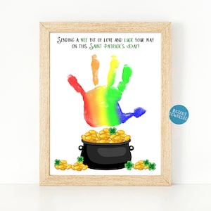 May include: A rainbow handprint with a pot of gold and shamrocks. The text reads "Sending a wee bit of love and luck your way on this Saint Patrick's Day!"
