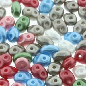 May include: Assortment of small, oval-shaped glass beads in various colors, including pink, blue, green, red, and gray. The beads have a smooth, glossy finish.