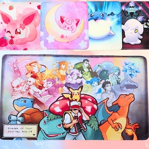 May include: A collection of colorful mousepads featuring various cartoon characters and designs. The top row includes a pink fox with a strawberry, a pink character in a crescent moon, a blue creature, and a white ghost-like figure. The bottom mousepad has a large group of characters with the text "Shades of Your Journey Await!"