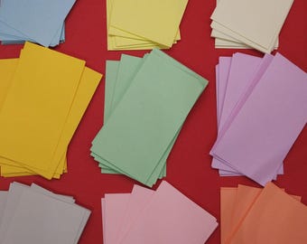 Piezas de papel de origami cortadas con precisión y desplegadas: colores y tamaños variados para manualidades, arte modular y proyectos de papel personalizados.