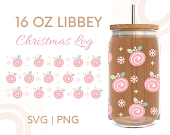 May include: A clear 16 oz Libbey glass with a wooden lid and a silver straw. The glass is decorated with pink and white Christmas ornaments, snowflakes, and stars. The words "Christmas Log" are written in pink script.