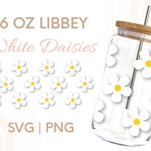 May include: A 16 oz. clear glass tumbler with a wooden lid and a straw. The tumbler is decorated with white daisies with yellow centers. The text "16 OZ LIBBEY White Daisies SVG | PNG" is printed on a white background.