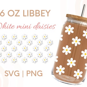 May include: A 16 oz Libbey glass with a brown background and white daisy pattern. The text "White mini daisies" is written in pink above the glass. The text "SVG | PNG" is written in brown below the glass.