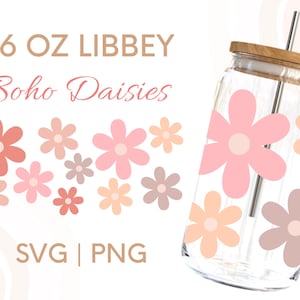 May include: A 16 oz. glass jar with a wooden lid and a straw. The jar is decorated with pink, peach, and brown daisy flowers. The text "16 oz LIBBEY Boho Daisies SVG | PNG" is printed on a white background.
