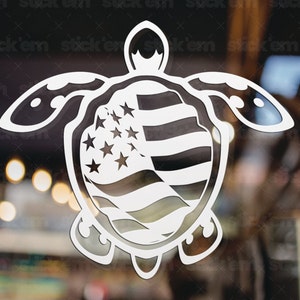 May include: A white vinyl sticker of a turtle with an American flag design. The turtle is facing forward with its head up and its legs outstretched. The flag is draped over the turtle's shell.