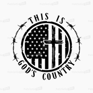 May include: Black and white graphic design with a distressed circle containing an American flag and a cross. The text "This is God's Country" is written around the circle with barbed wire on either side.