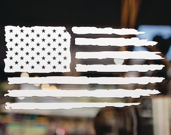 May include: A white distressed American flag decal with a faded, worn look. The stars are black and the stripes are white.