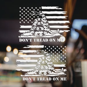 May include: A white vinyl sticker with a distressed American flag design featuring a coiled rattlesnake with the words "Don't Tread On Me" below.