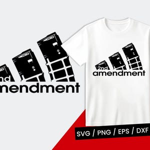 May include: White t-shirt with a black graphic. The design shows three black rectangular shapes in a diagonal pattern, with the words "2nd amendment" in a bold, black font below. The shirt is set against a white background.