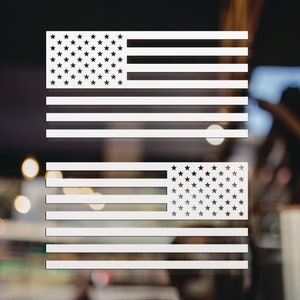 May include: Two white vinyl decals of the American flag. The flags are in a horizontal orientation with the stars on the left side and the stripes on the right side.