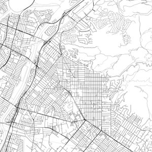 May include: A black and white aerial map of a city with a grid-like street layout. The map shows a network of roads, streets, and highways.