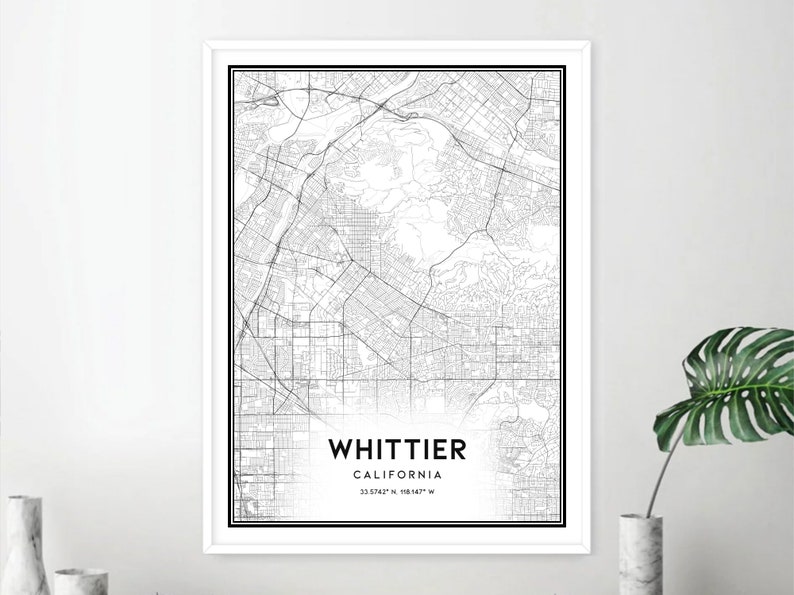 May include: Black and white map print of Whittier, California. The map shows the city streets and surrounding areas. The text "WHITTIER, CALIFORNIA 33.9742&deg; N, 118.0427&deg; W" is printed at the bottom of the map.