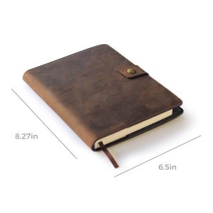 May include: A brown leather bound journal with a brass button closure. The journal measures 8.27 inches by 6.5 inches.