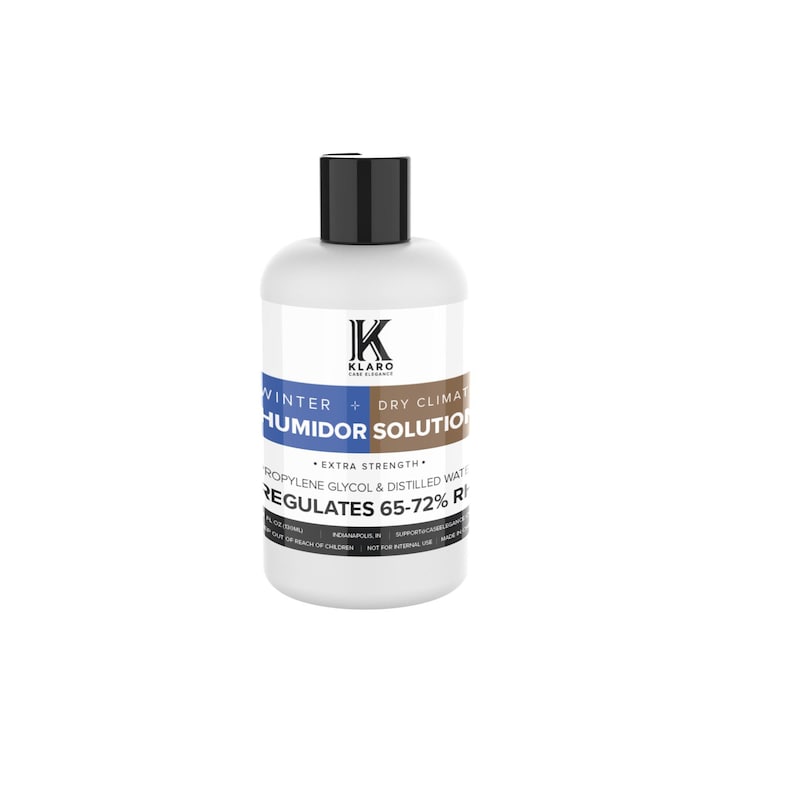 May include: A white plastic bottle with a black cap labeled "KLARO Cigar Accessories" and "WINTER + DRY CLIMATE HUMIDOR SOLUTION". The bottle also says "EXTRA STRENGTH" and "PROPYLENE GLYCOL & DISTILLED WATER REGULATES 65-72% RH".
