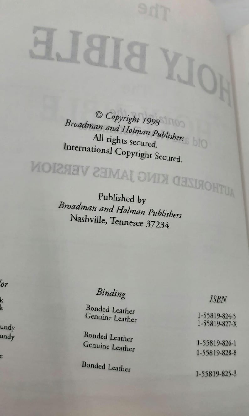 May include: Open book page with text from "The Holy Bible". Copyright 1998 by Broadman and Holman Publishers. Includes ISBN numbers and binding information. The text is printed in black on a white background.